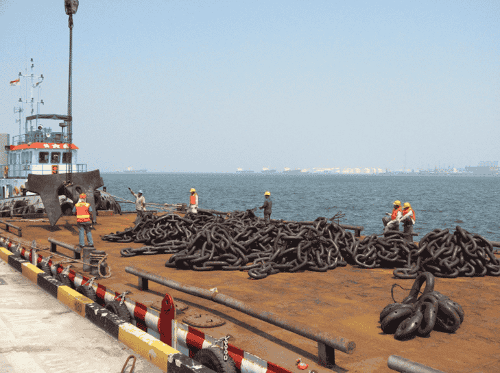 Anchor and chains being loaded onto a barge
